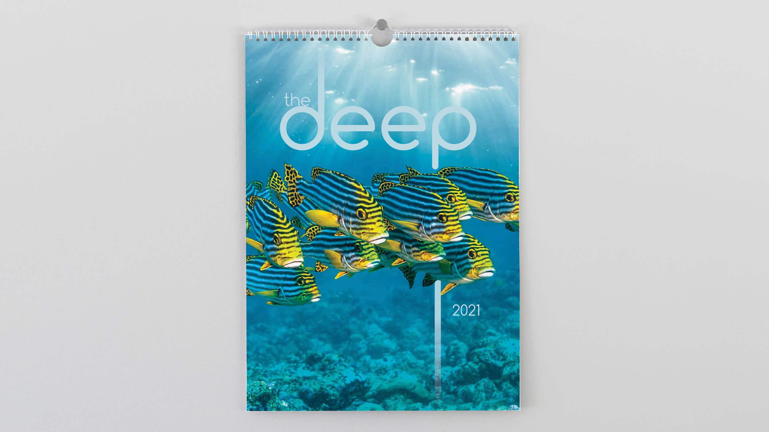 'The Deep' wall calendar with blue and yellow tropical fish on the cover