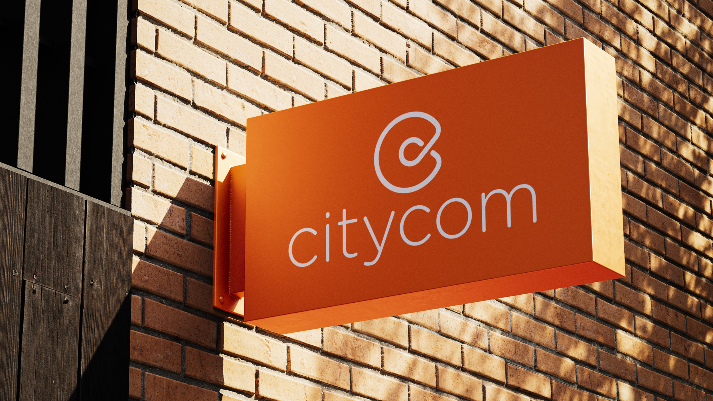 Citycom sign on the side of a brick building